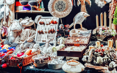 Linen, earrings and accessories at stalls during Christmas market in winter Riga in Latvia. Europe on winter. Street Xmas and holiday fair. Advent Decoration and Stalls with Crafts Items on Bazaar