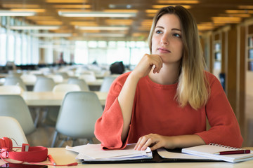 Young female student studying in the library.