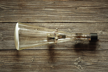Old cathode ray tube kinescope on a wood background