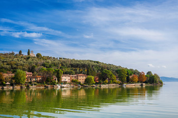 Fototapeta na wymiar Isola Maggiore (Greater Island) of Lake Trasimeno in Umbria, with small village and the medieval St Micheal Archangel church at the top