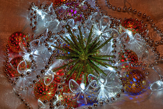 Volumetric Green Snowflake On The Background Of Luminous Garlands And Shiny Beads