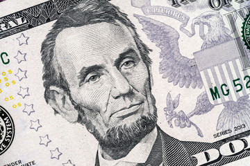 Close-up portrait of Abraham Lincoln on a 5 US dollars banknote.