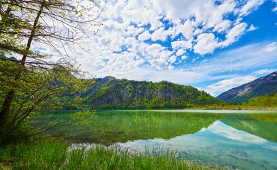 Beautiful Offensee lake landscape with mountains, forest, clouds and reflections in the water in Austrian Alps. Salzkammergut region.