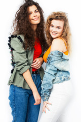 young pretty teenage girls friends with blond and brunette curly hairs posing cheerful isolated on white background, lifestyle people concept