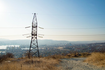 high voltage power transmission line on background of blue sky