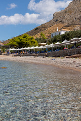 Fototapeta na wymiar Mountain and Vlychos Plakes Beach in Hydra Island