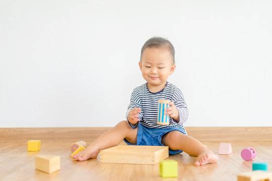 2 years baby boy.Little child boy playing with lots of wooden toys block with mother.Kids play with educational toys at home.Day care and Kindergarten school.child development concept.