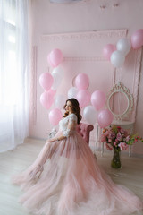 Wedding photo of a beautiful woman in a pink dress in full growth.