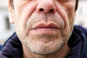 Unshaven face of a middle-aged Caucasian man close-up.