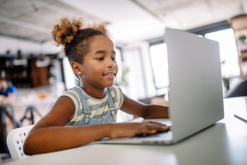 Girl spending time with notebook and modern technology