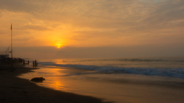 People walking on the beach of Tonsupa at sunset