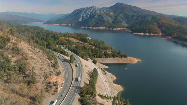 Aerial Flying Over A Calm Lake Shasta Reservoir In California, USA. The Lake Is At A Lower Level Indicating A Drought