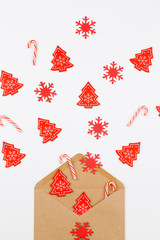 Christmas red tree , snowflakes and lollipop flowing from envelope on white background