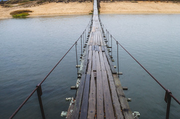 Walk on the suspension bridge. The way to the other side of the river on the suspension bridge.