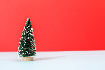Small christmas tree on blue and red background