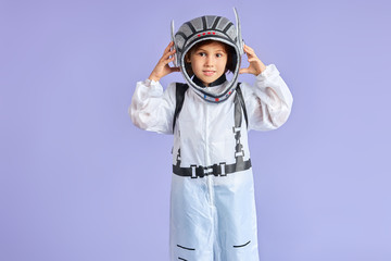 Caucasian little boy in white protective suit and helmet on head stand isolated over copy space, look at camera © alfa27