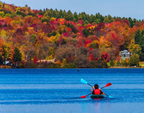 two kayakers  heading home on lake elmore on a beautiful fall day 