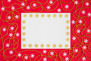 Christmas mockup with snowflakes and gold garland on red background. Happy new year. Space for text. Winter concept.