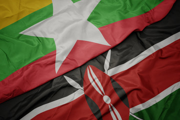waving colorful flag of kenya and national flag of myanmar.