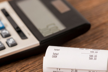 Grocery bill close up with calculator background