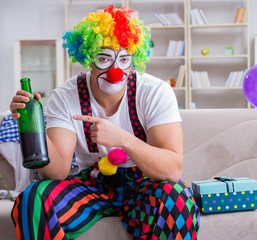 Drunk clown celebrating having a party at home