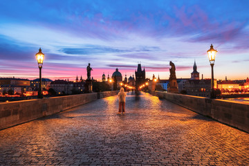 Fototapeta na wymiar Charles Bridge along is beautiful view of Old Town buildings in sunrise in Prague
