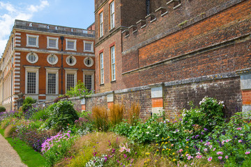 Fototapeta na wymiar London, UK. English garden view and the East Front of Hampton court 17th century locates West London