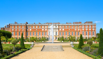 London, UK. English garden view and the East Front of Hampton court 17th century locates West London