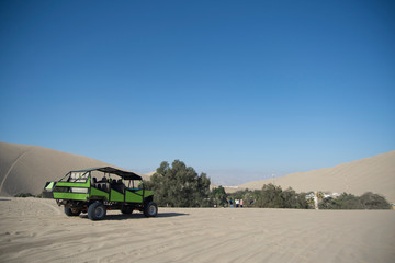 Tubular vehicle riding the dunes in Huacachina, ica desert, Peru