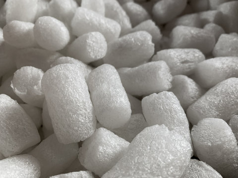 White polystyrene plastic foam elements within a parcel, to secure a safe transport.