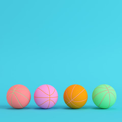 Four basketball balls on bright blue background in pastel colors. Minimalism concept