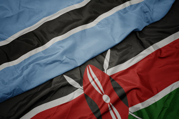 waving colorful flag of kenya and national flag of botswana.