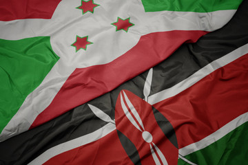 waving colorful flag of kenya and national flag of burundi