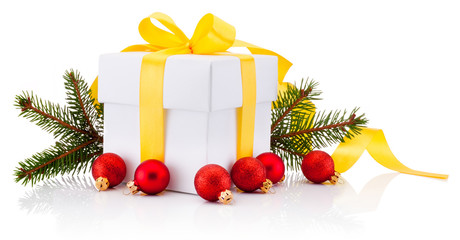 White gift box tied yellow ribbon bow, Christmas baubles and fir tree branch Isolated on white background