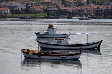 Naklejka na ściany i meble Moored boats with reflections. fishing boat at the Cunda Balıkesir TURKEY.
