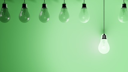 Hanging light bulbs on green background