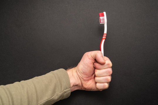 red toothbrush on black background