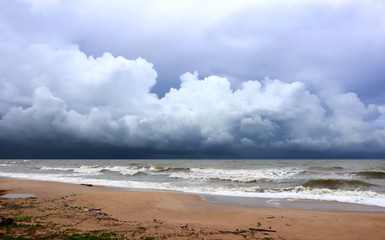 Fototapeta na wymiar Lonely beach with view over the sea to dramatic looking storm clouds.