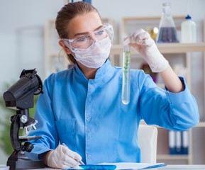 Female scientist researcher conducting an experiment in a labora