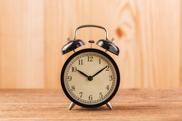 Alarm clock on wooden table close up