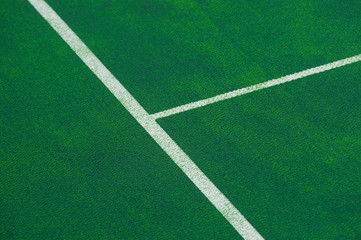 Tennis court indoor with green carpet surface