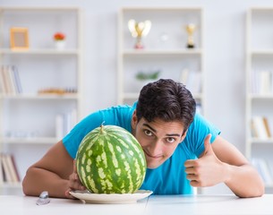 Fototapeta premium Man eating watermelon at home