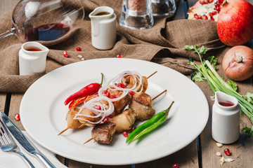Grilling pork shashlik on barbecue grill with sauces tkemali and satsebeli Selective focus
