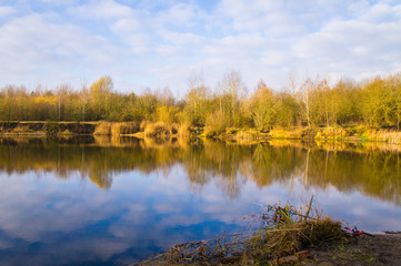 Fototapeta na wymiar Autumn forest beautiful lake with blue sky.