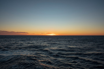 Fototapeta na wymiar sun set in ocean horizon with orange color