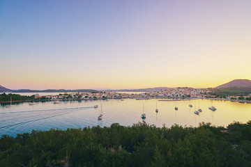 Travel by Greece. Beautiful view of Ermioni sea lagoon with moored yachts at sunset time.
