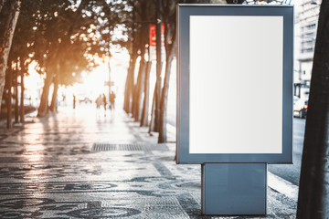 Mockup of a blank information poster on paving-stone outdoors; an empty vertical street banner template in a park; an outdoor billboard placeholder mock-up on a city boulevard in an alleyway