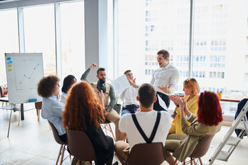 Young successful team of business people celebrate together their win in business project, isolated...