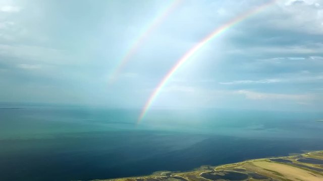 aerial view of double rainbow over the sea, aerial view of Rainbow above the sea and island, aerial view of Dzharylgach island with raindbow,  aerial view of lakes on the island and double rainbow
