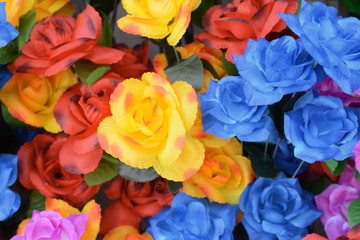 Fototapeta na wymiar Beautiful multicolored artificial flowers background